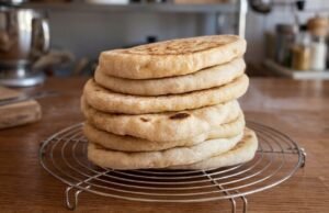Home-Made Turkish Bread (Bazlama) Stack of homemade bazlama Turkish flatbreads on cooling rack in kitchen